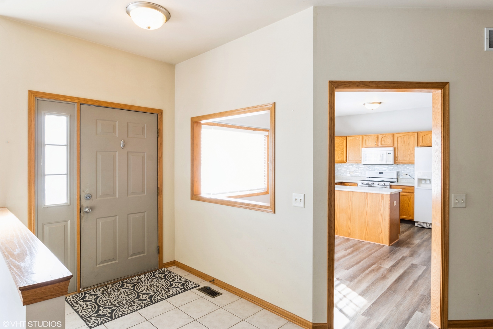 1326 Dancing Bear Lane Elgin, IL 60120 - Photo 3 of 28 a view of a hallway with wooden floor and a living room