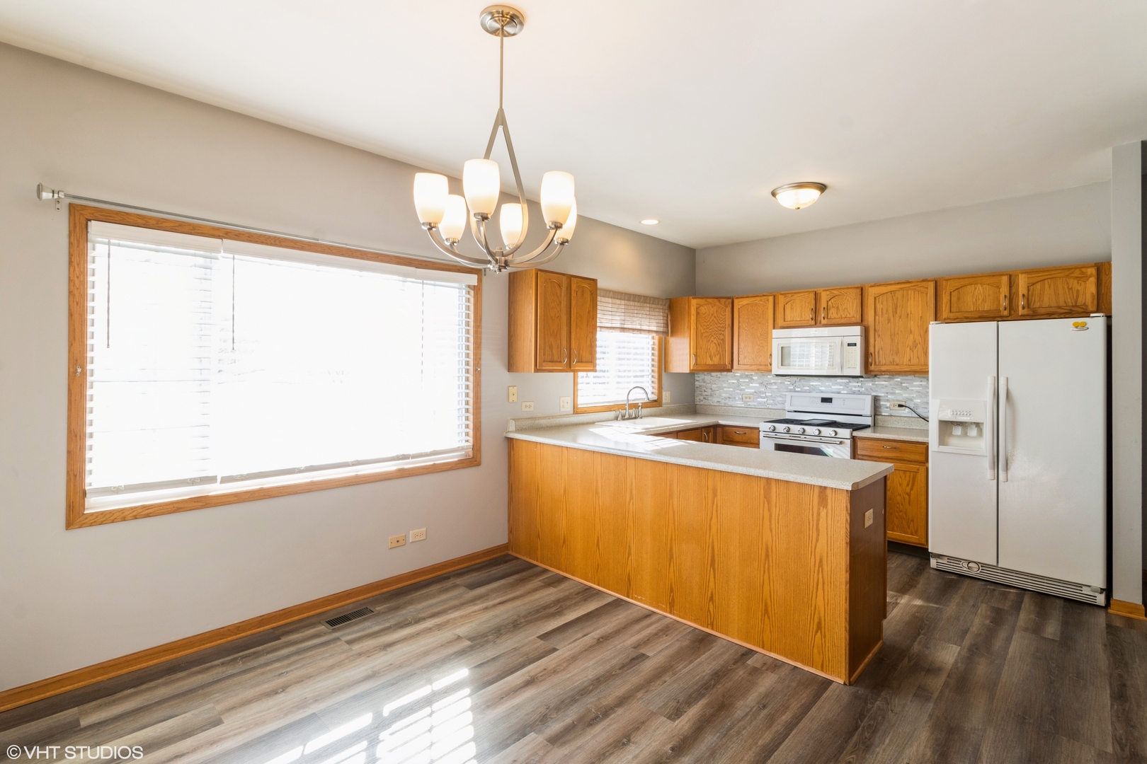 1326 Dancing Bear Lane Elgin, IL 60120 - Photo 4 of 28 a kitchen with stainless steel appliances granite countertop a refrigerator a sink dishwasher a stove and white countertops with wooden floor