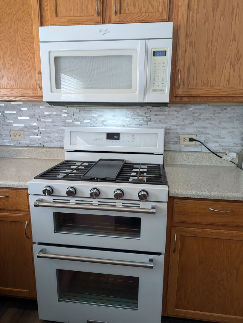 1326 Dancing Bear Lane Elgin, IL 60120 - Photo 9 of 28 a stove top oven sitting inside of a kitchen