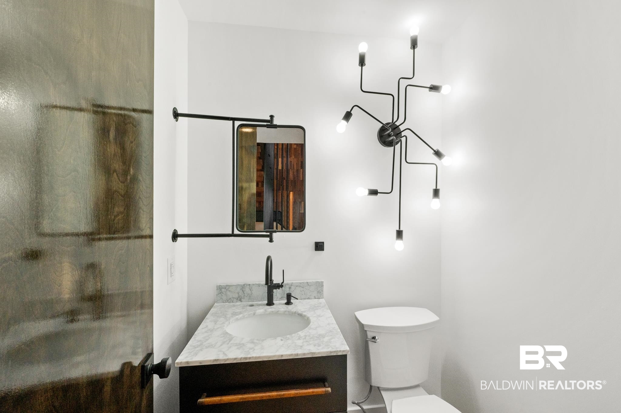 33349 River Road Orange Beach, AL 36561 - Photo 28 of 61 Modern bathroom featuring a single vanity with a white countertop, an undermount sink, and a matte black faucet