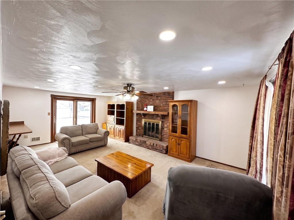 151 Stone Quarry Road Aliquippa, PA 15001 - Photo 5 of 26 Livingroom with beautiful gas fireplace, large windows for natural light and breakfast bar. Slider to back deck has built in blinds