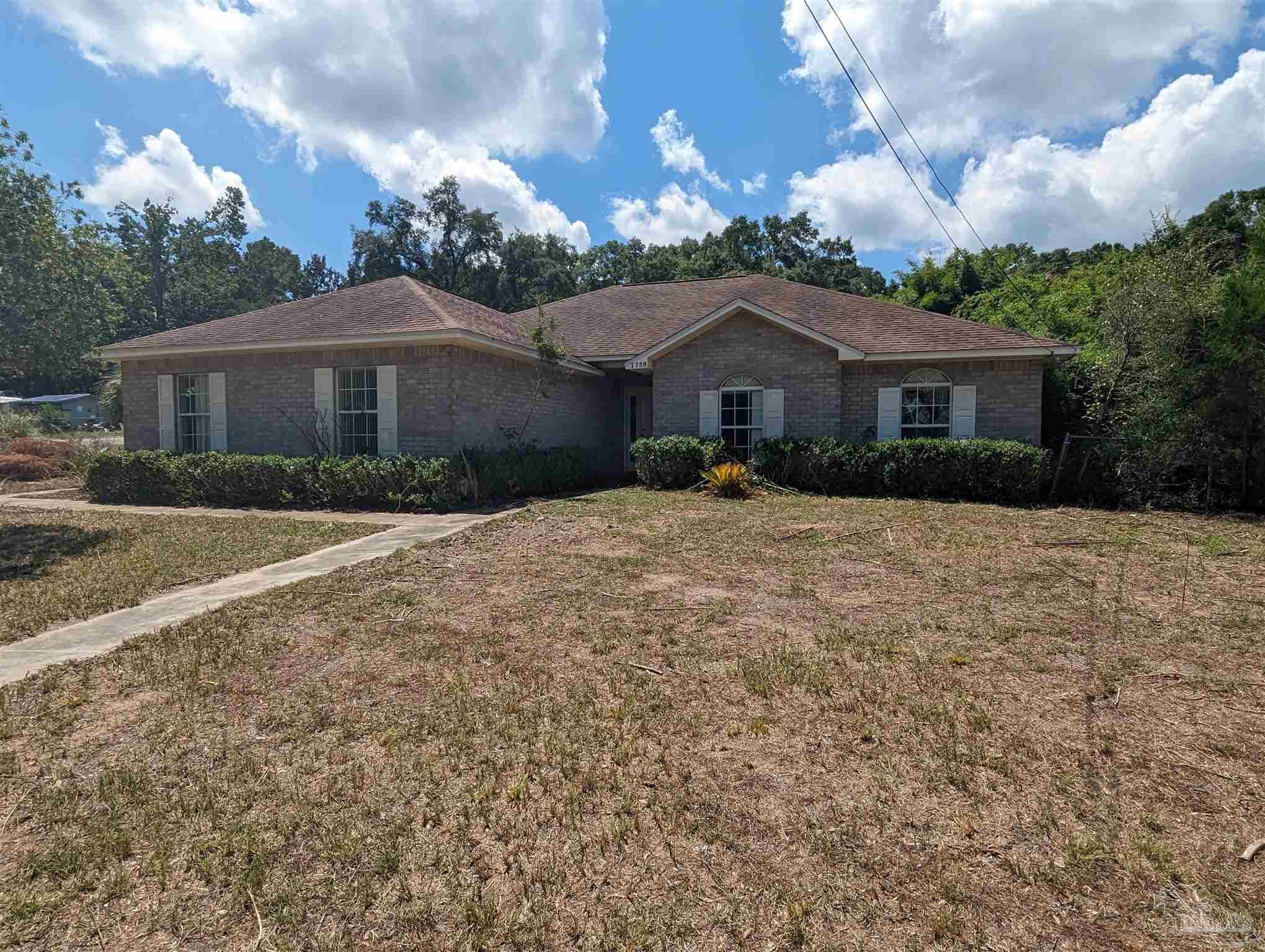 7759 Erudition Avenue Milton, FL 32583 - Photo 1 of 22 a view of house with a yard