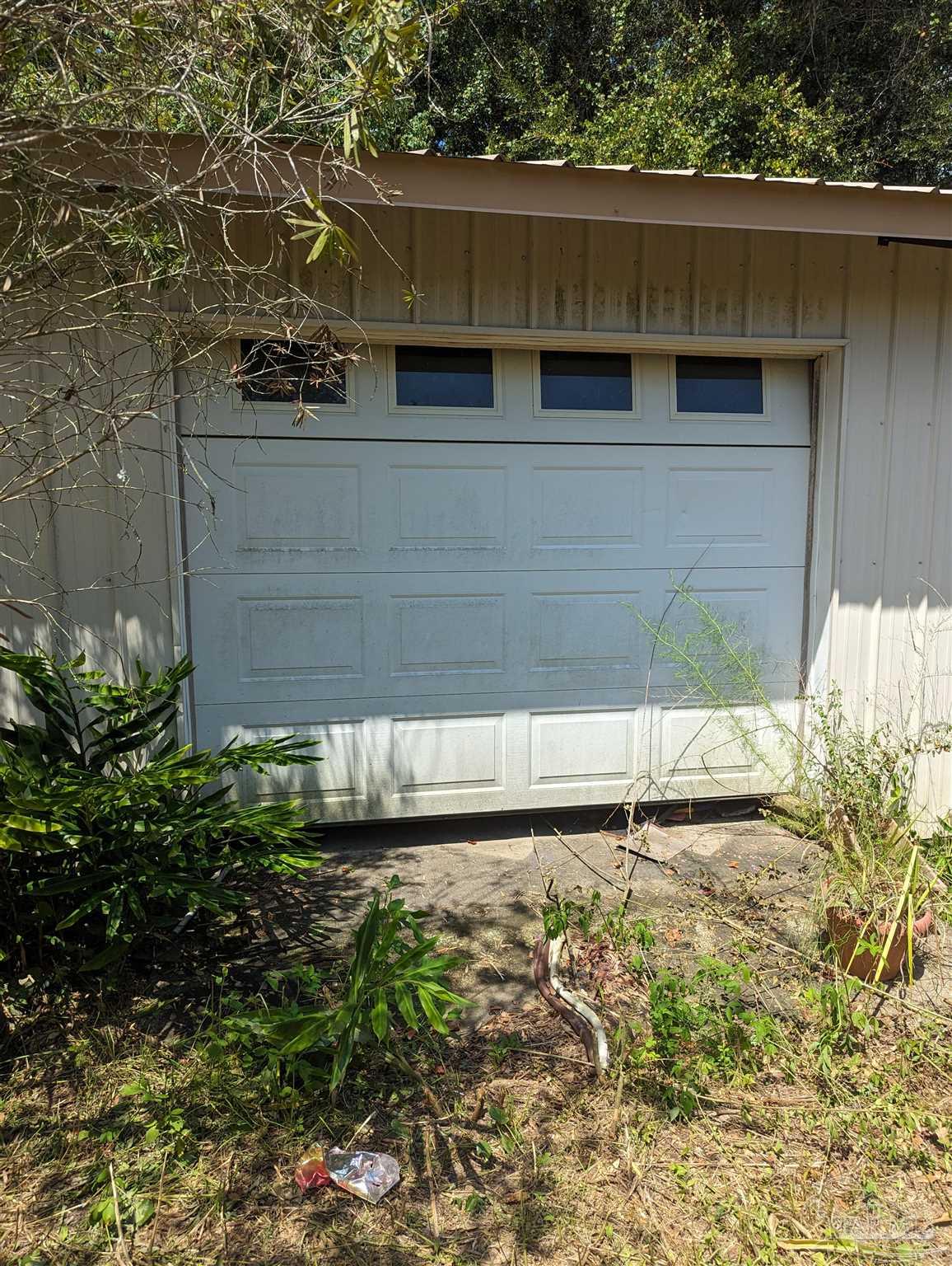 7759 Erudition Avenue Milton, FL 32583 - Photo 11 of 22 a view of backyard with wooden fence and plants