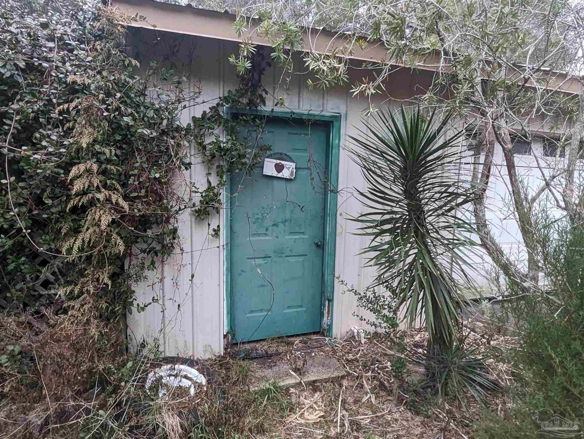 7759 Erudition Avenue Milton, FL 32583 - Photo 12 of 22 a front view of a house with a tree