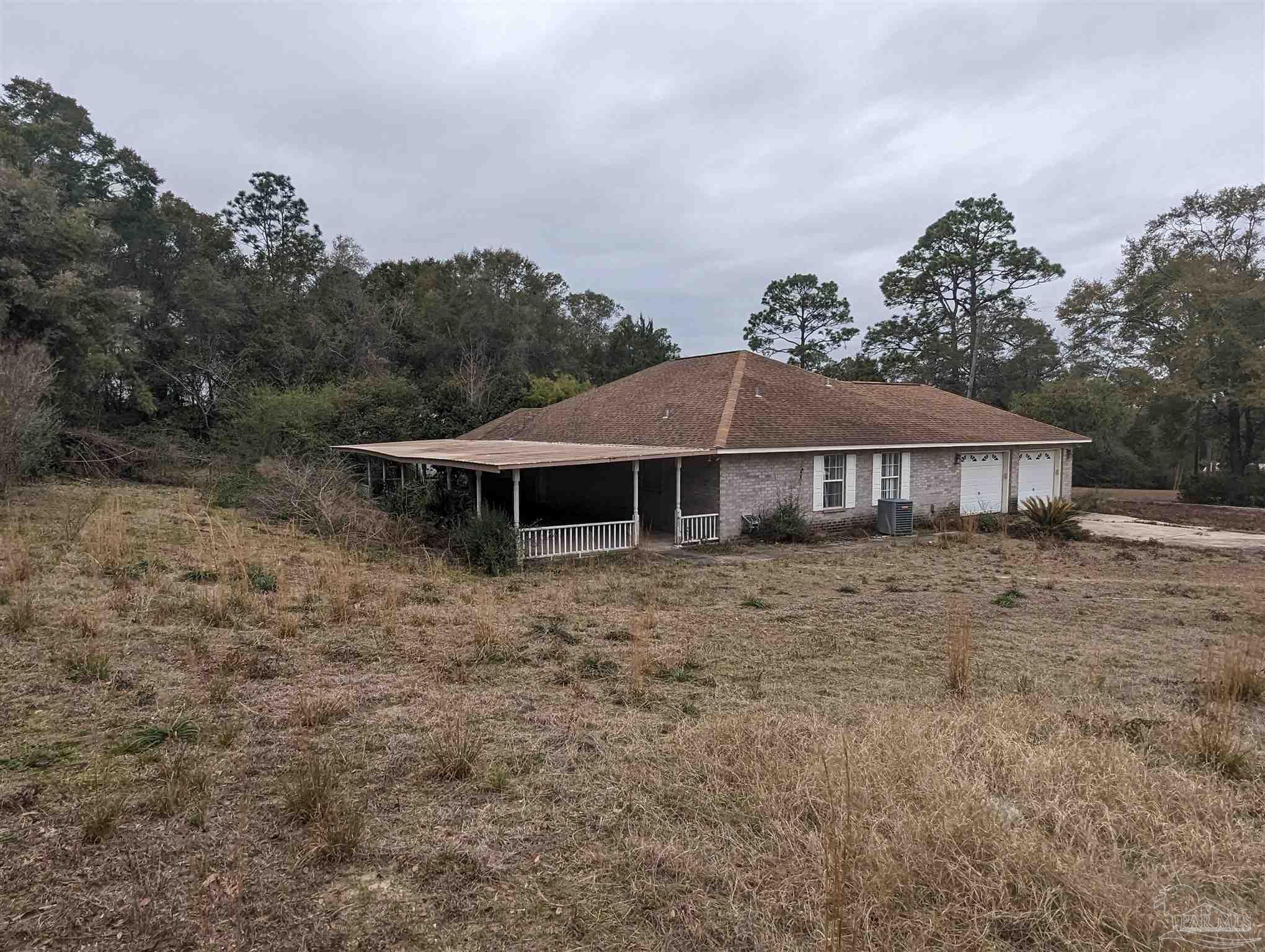 7759 Erudition Avenue Milton, FL 32583 - Photo 2 of 22 a front view of a house with a yard