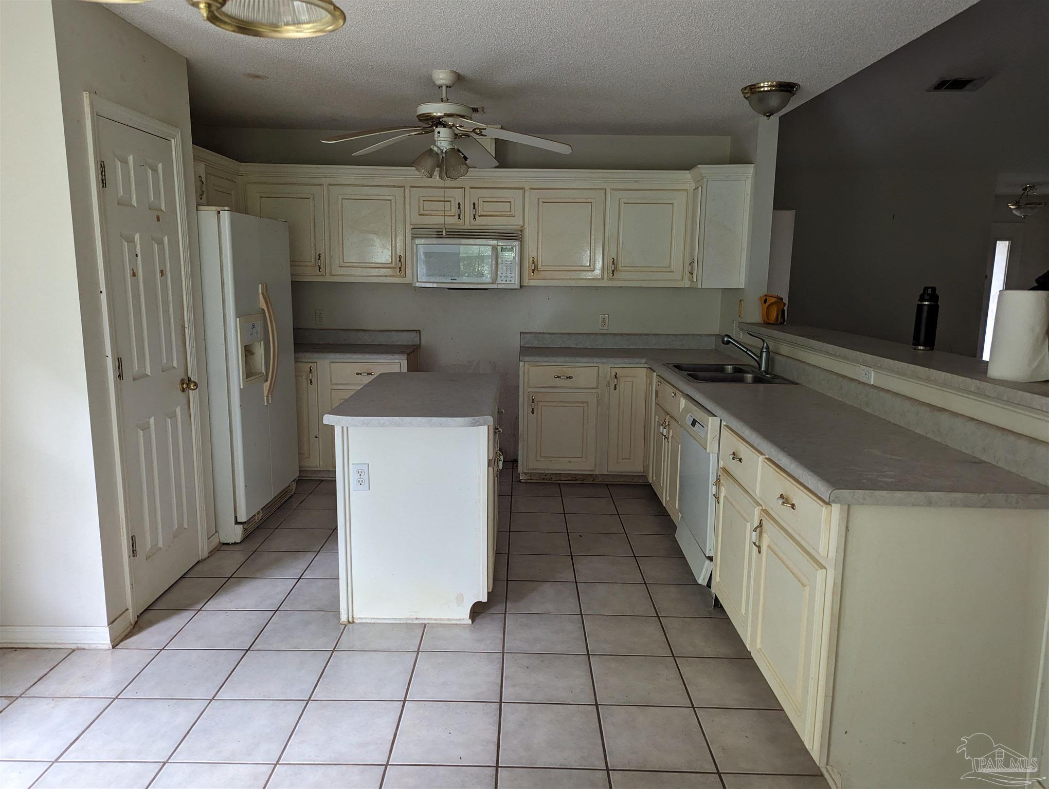 7759 Erudition Avenue Milton, FL 32583 - Photo 22 of 22 a kitchen with a sink and cabinets