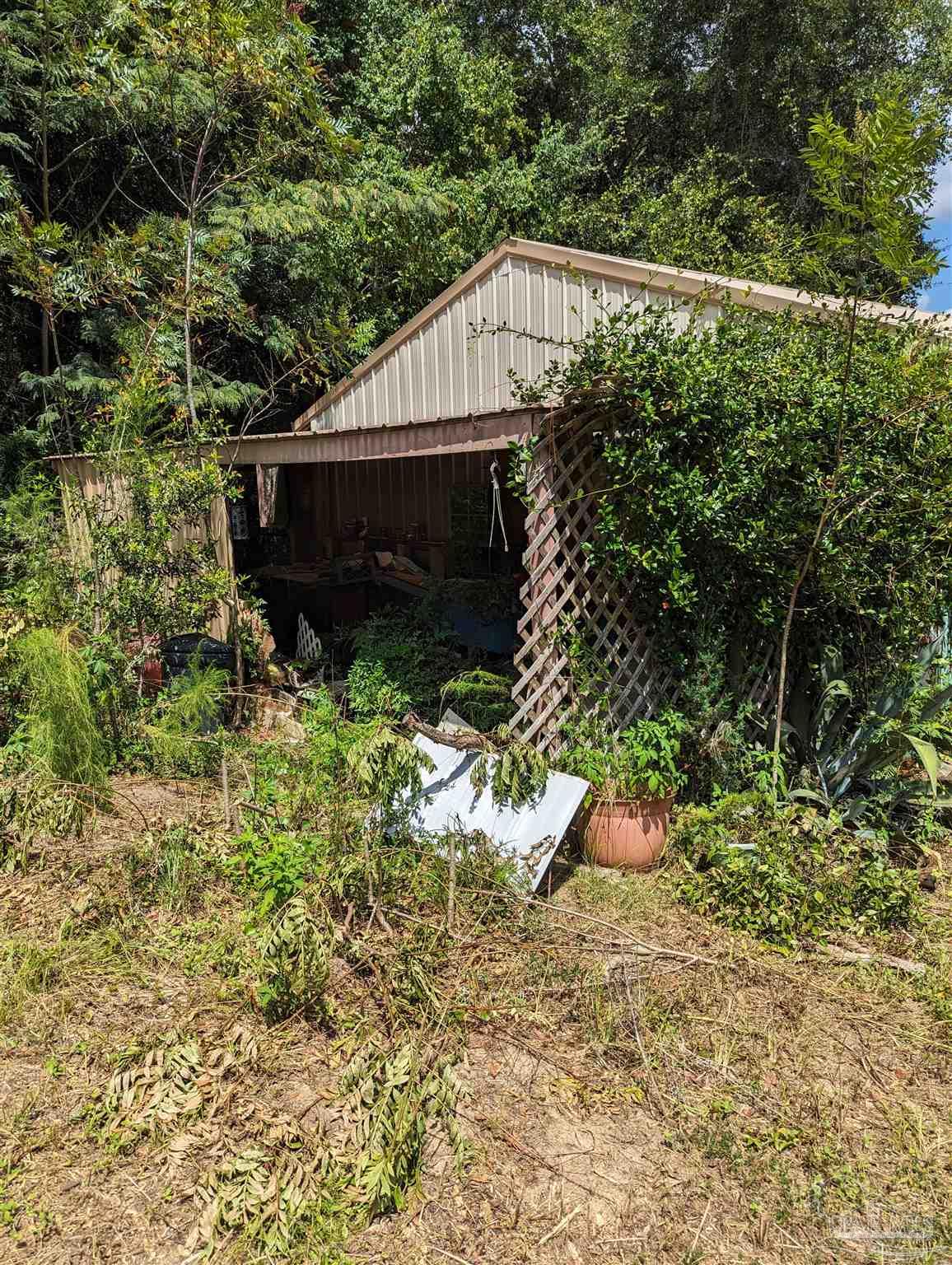 7759 Erudition Avenue Milton, FL 32583 - Photo 5 of 22 a view of a house with a yard