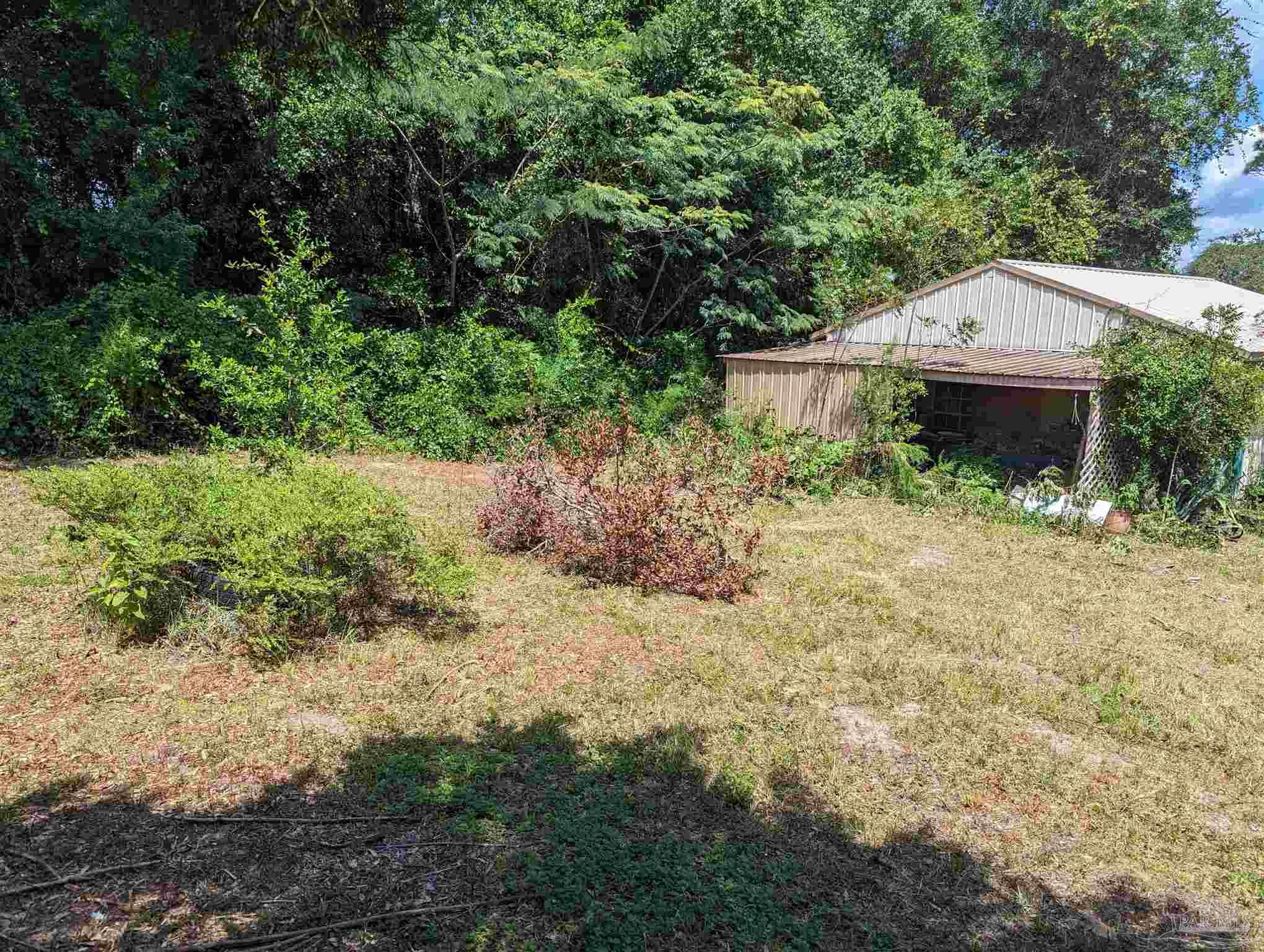 7759 Erudition Avenue Milton, FL 32583 - Photo 6 of 22 a front view of a house with a yard