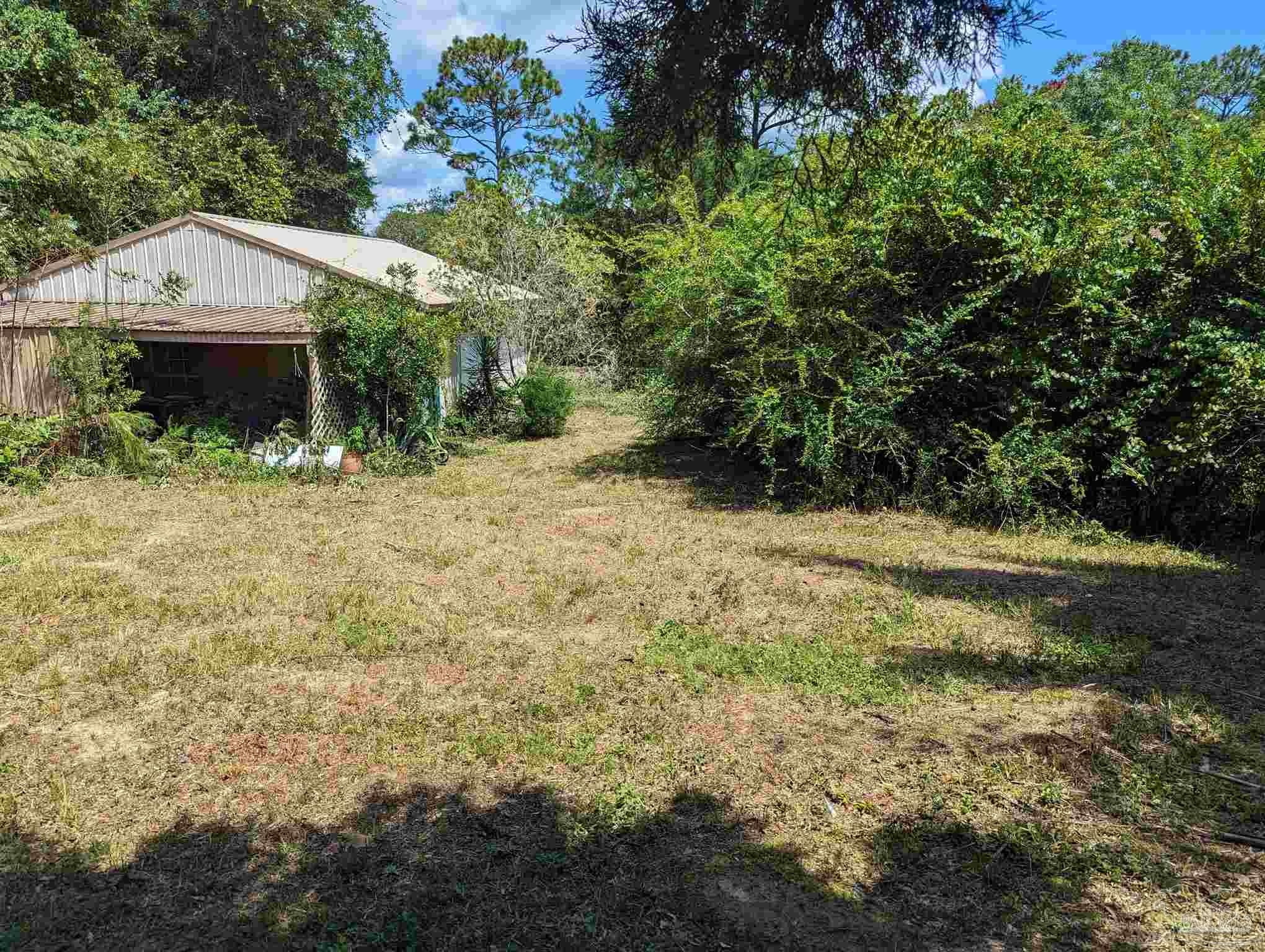 7759 Erudition Avenue Milton, FL 32583 - Photo 7 of 22 a view of a house with a yard