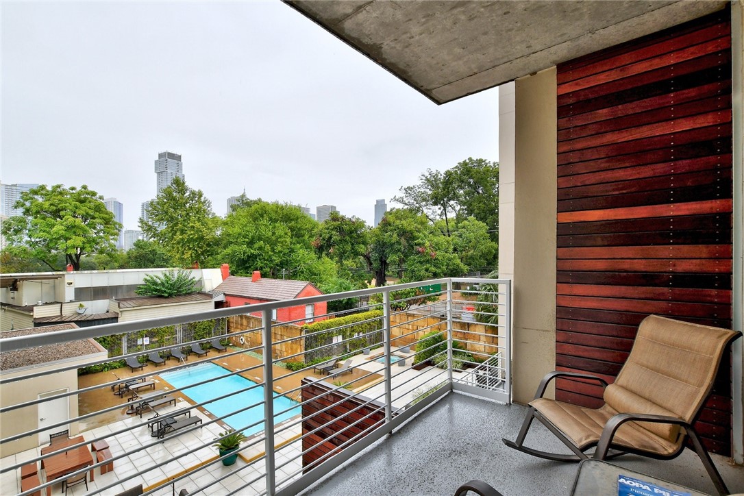a roof deck with a wooden table and chairs