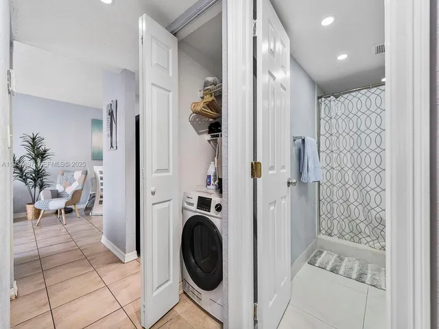 a view of a hallway with washer and dryer