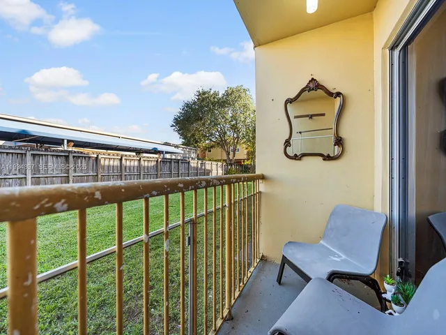 a view of a balcony with chairs