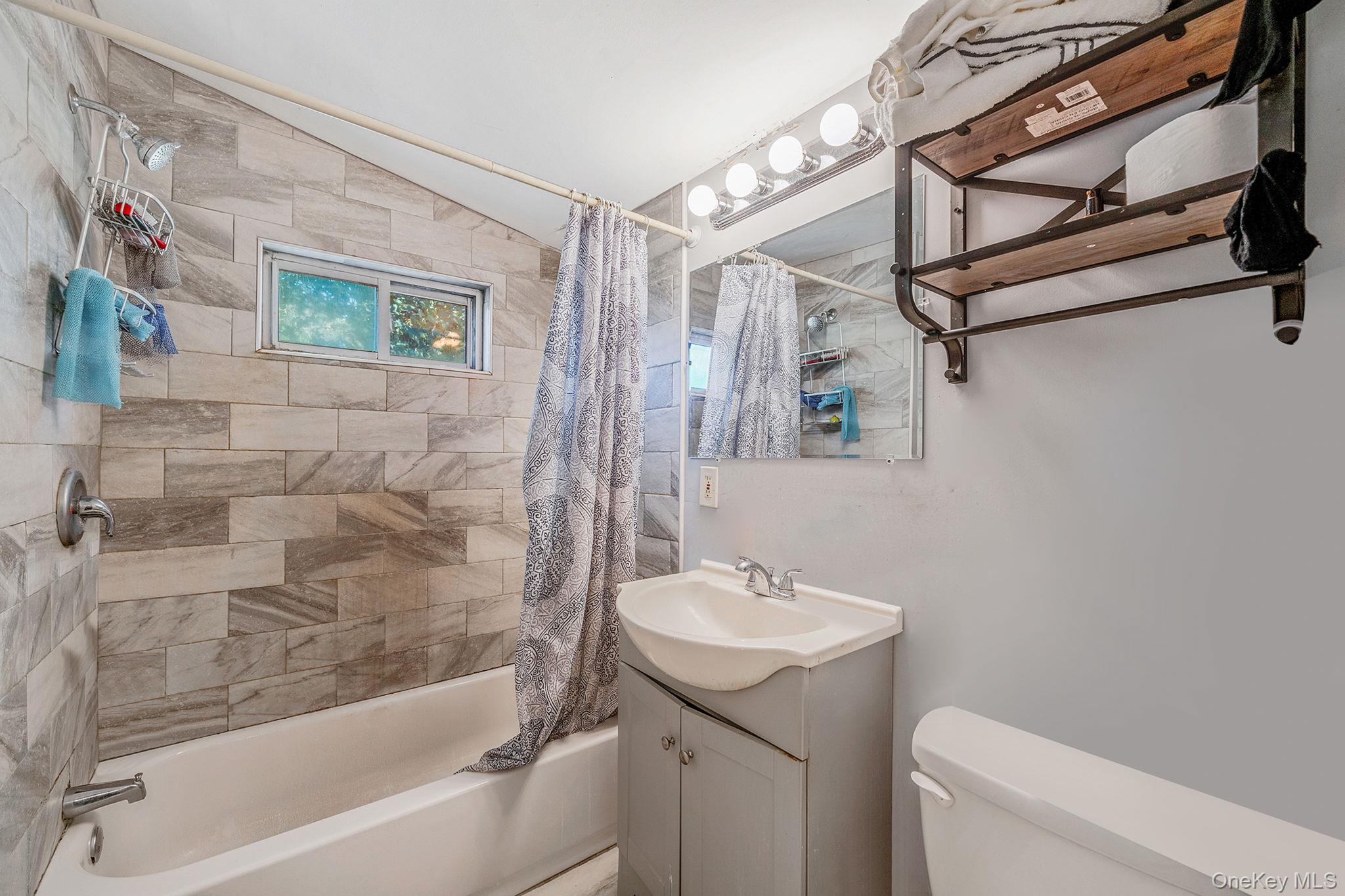15 Sayville Road Mastic Beach, NY 11951 - Photo 13 of 25 a bathroom with a sink and a bathtub