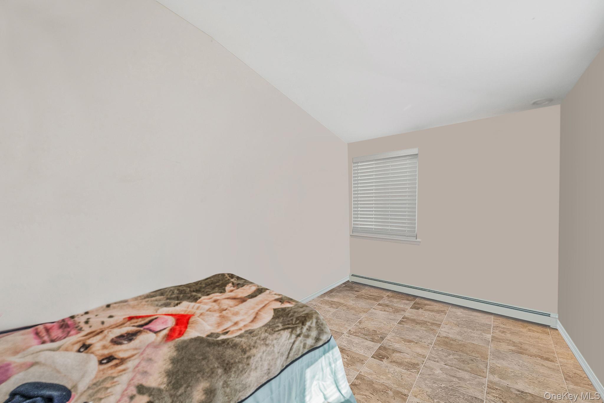 15 Sayville Road Mastic Beach, NY 11951 - Photo 14 of 25 a bedroom with a bed and a window