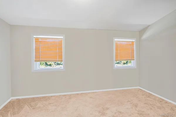 a view of an empty room with closet area