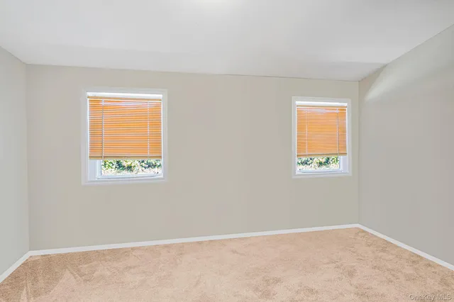 a view of an empty room with closet area