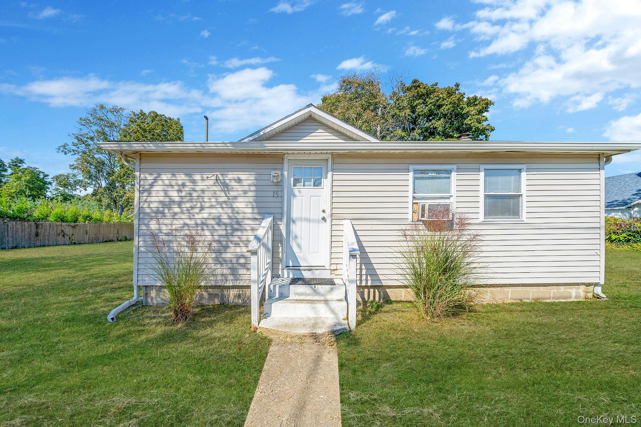 15 Sayville Road Mastic Beach, NY 11951 - Photo 2 of 25 a front view of a house with a yard