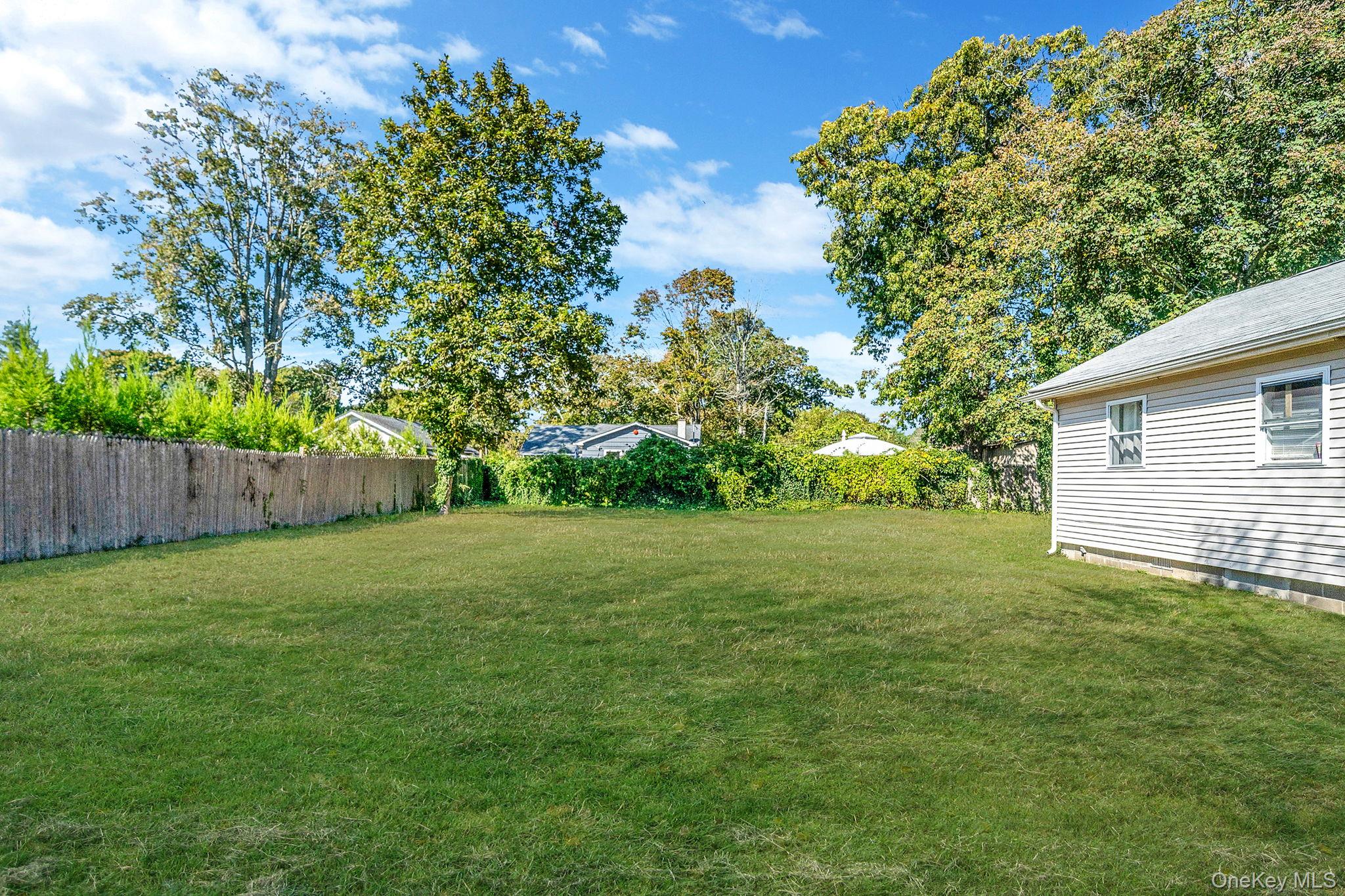 15 Sayville Road Mastic Beach, NY 11951 - Photo 20 of 25 a view of a backyard with a garden