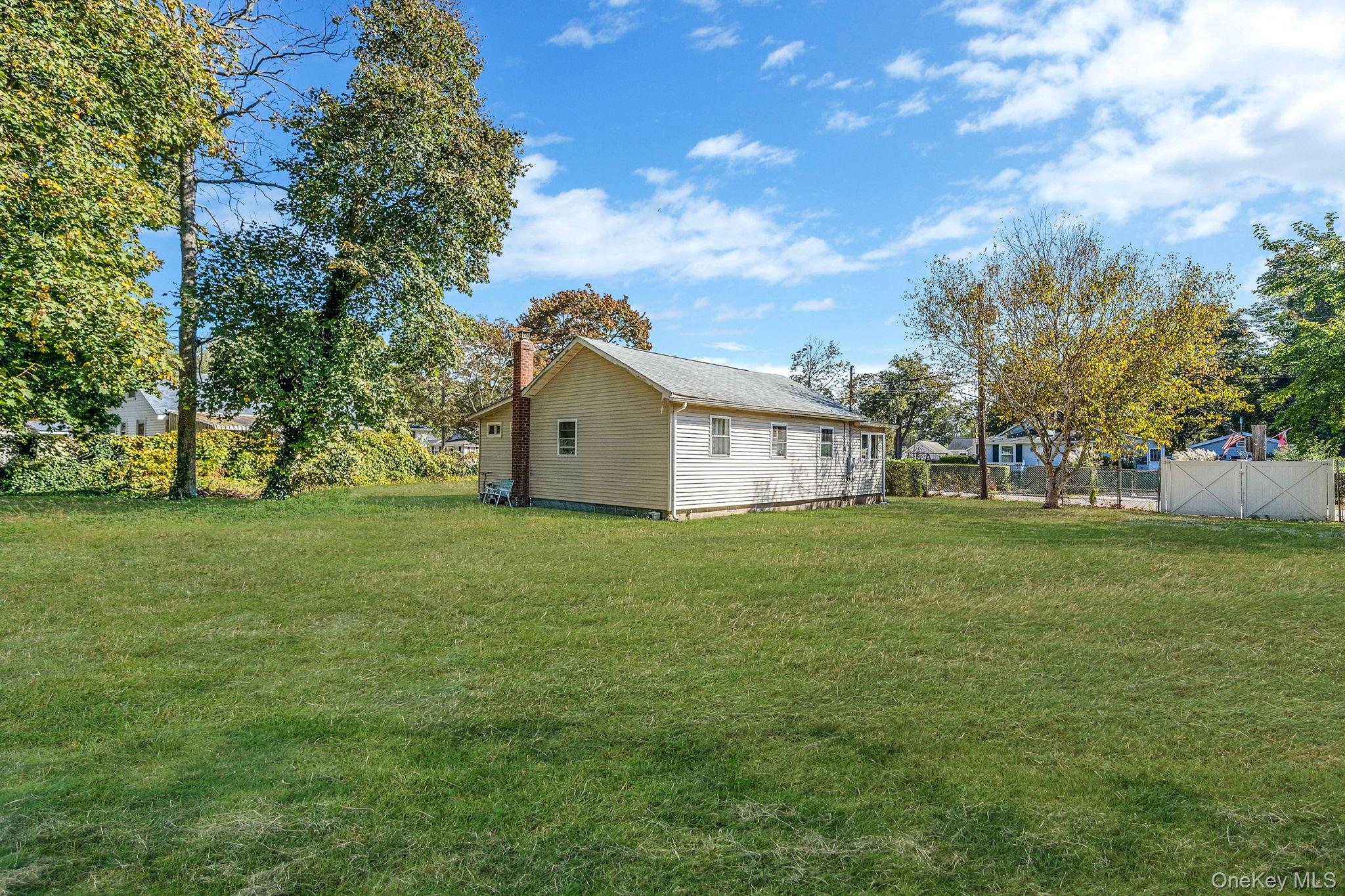 15 Sayville Road Mastic Beach, NY 11951 - Photo 21 of 25 a view of a house with backyard and garden
