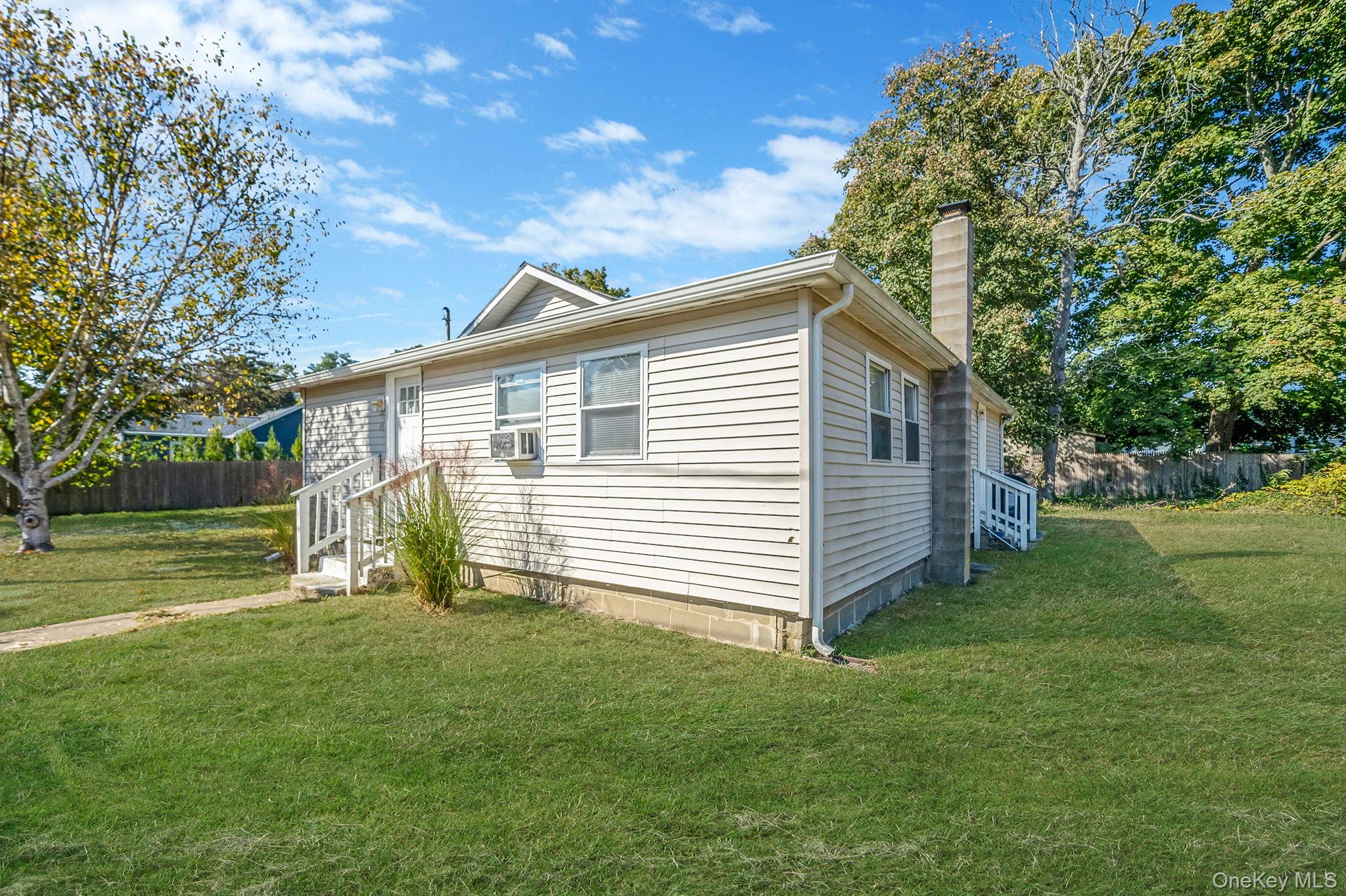 15 Sayville Road Mastic Beach, NY 11951 - Photo 3 of 25 a front view of a house with a garden