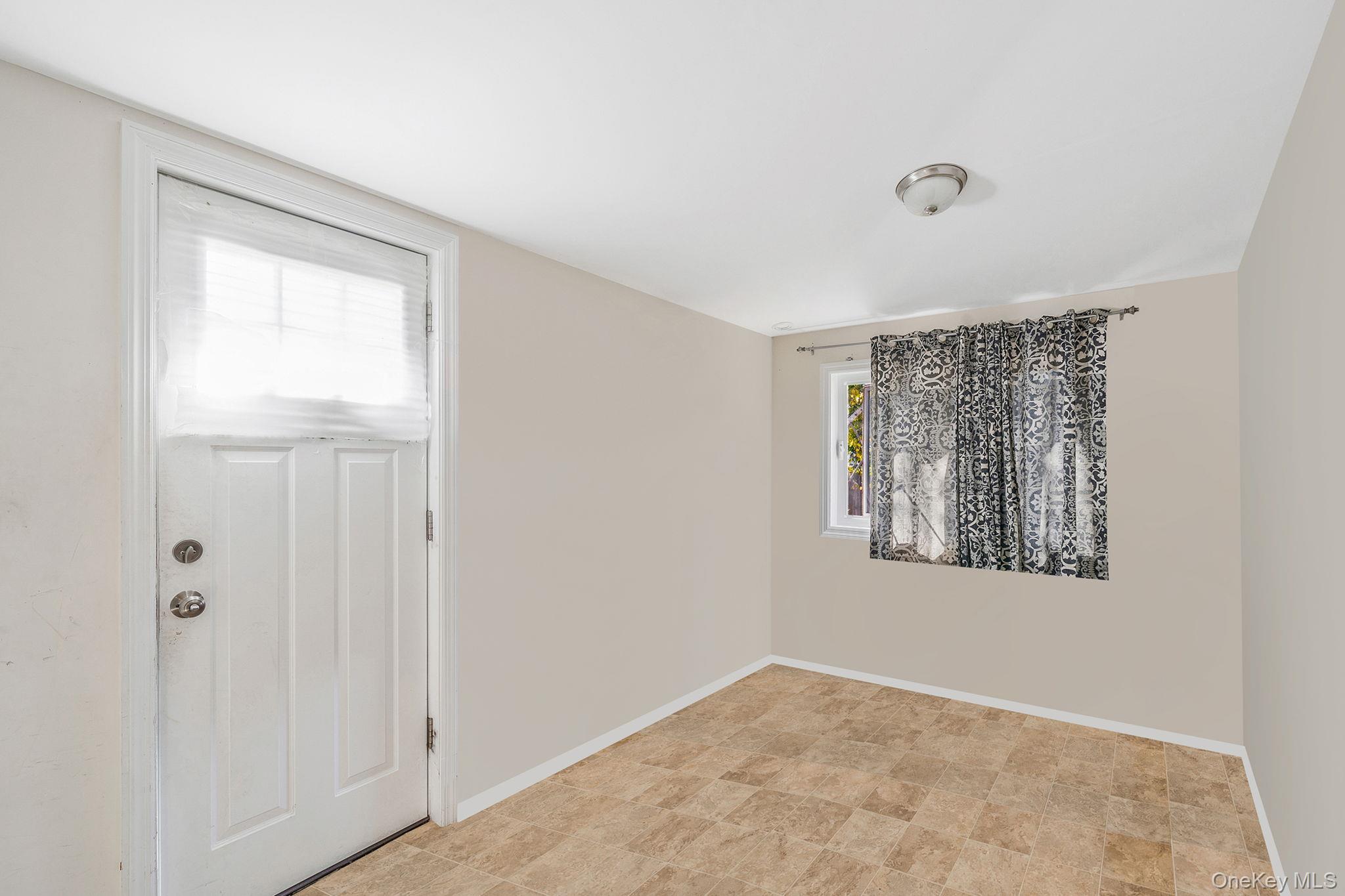 15 Sayville Road Mastic Beach, NY 11951 - Photo 5 of 25 a view of an empty room with window and closet area
