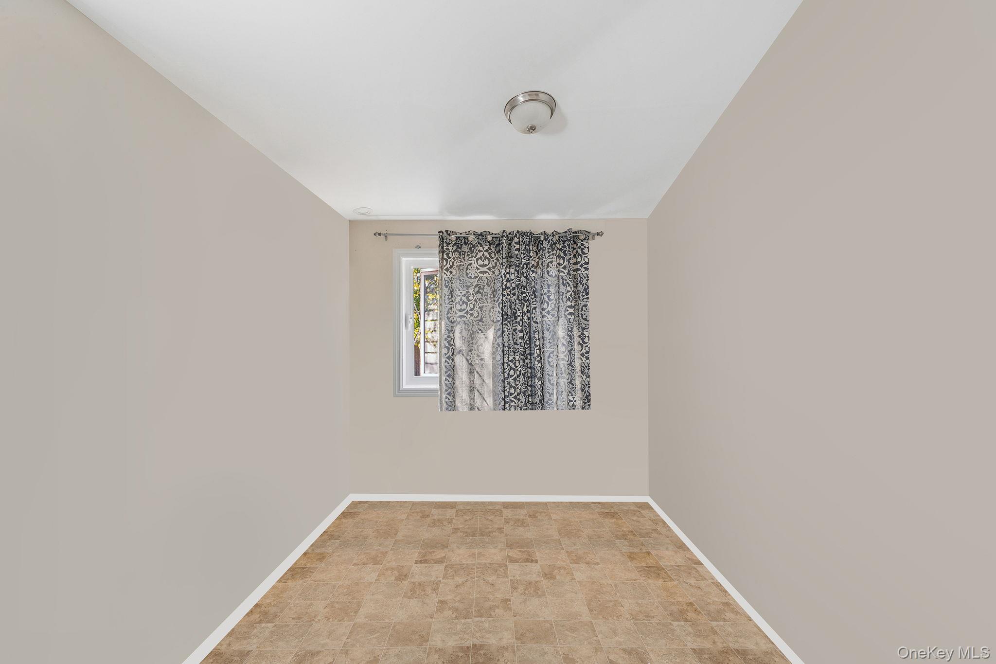 15 Sayville Road Mastic Beach, NY 11951 - Photo 6 of 25 an empty room with windows