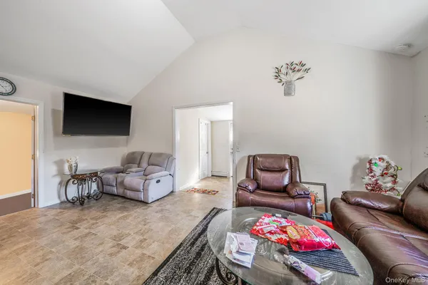 a bedroom with furniture and a flat screen tv