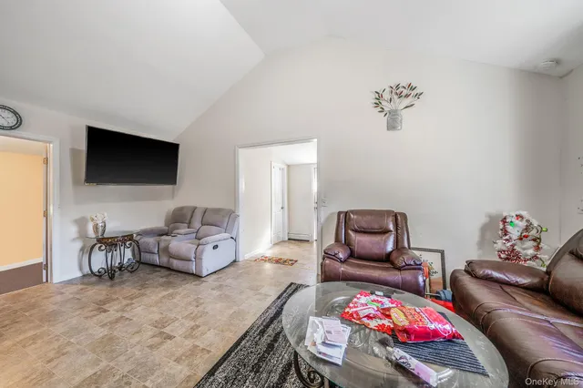 a bedroom with furniture and a flat screen tv