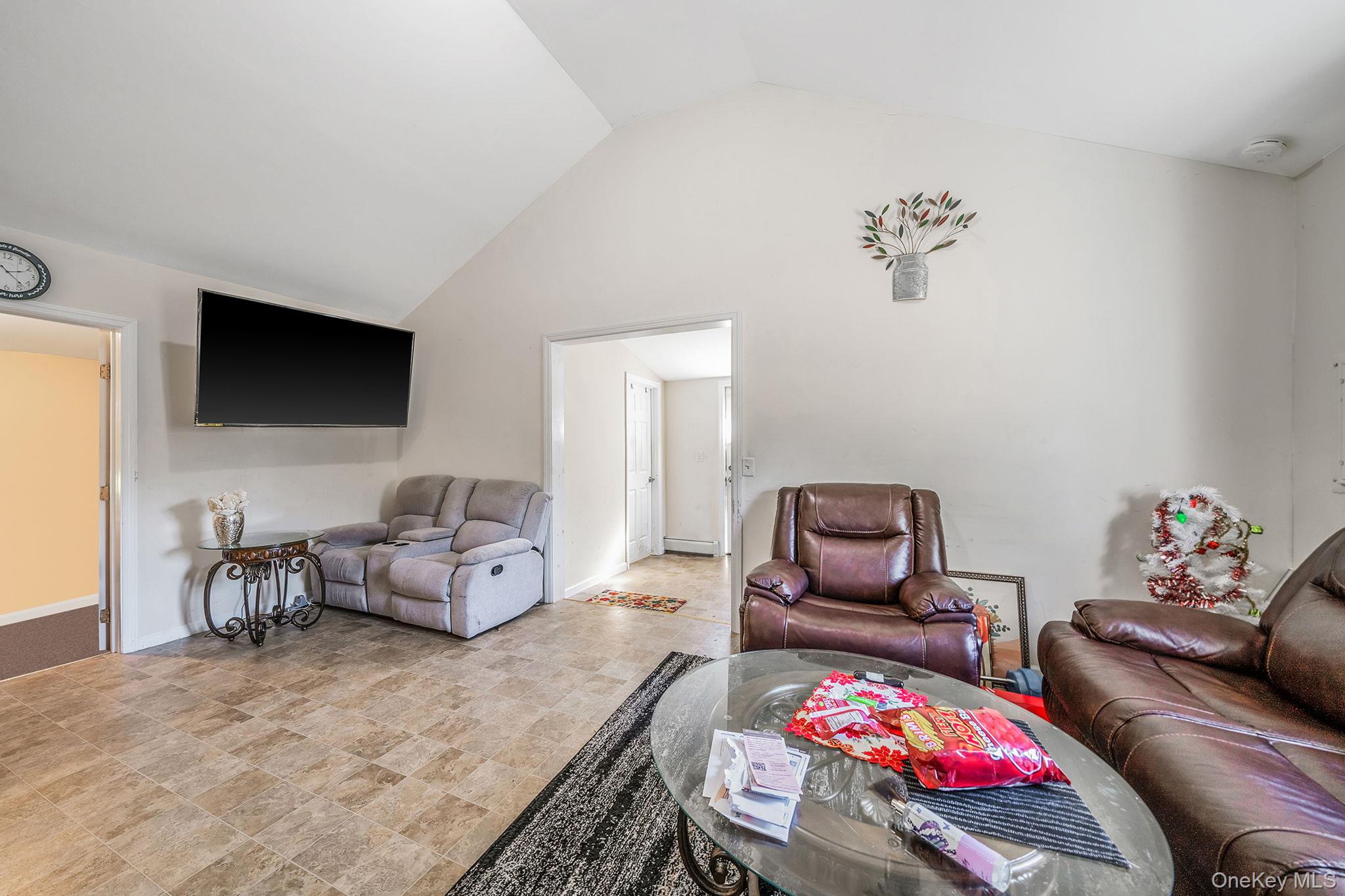 15 Sayville Road Mastic Beach, NY 11951 - Photo 7 of 25 a bedroom with furniture and a flat screen tv