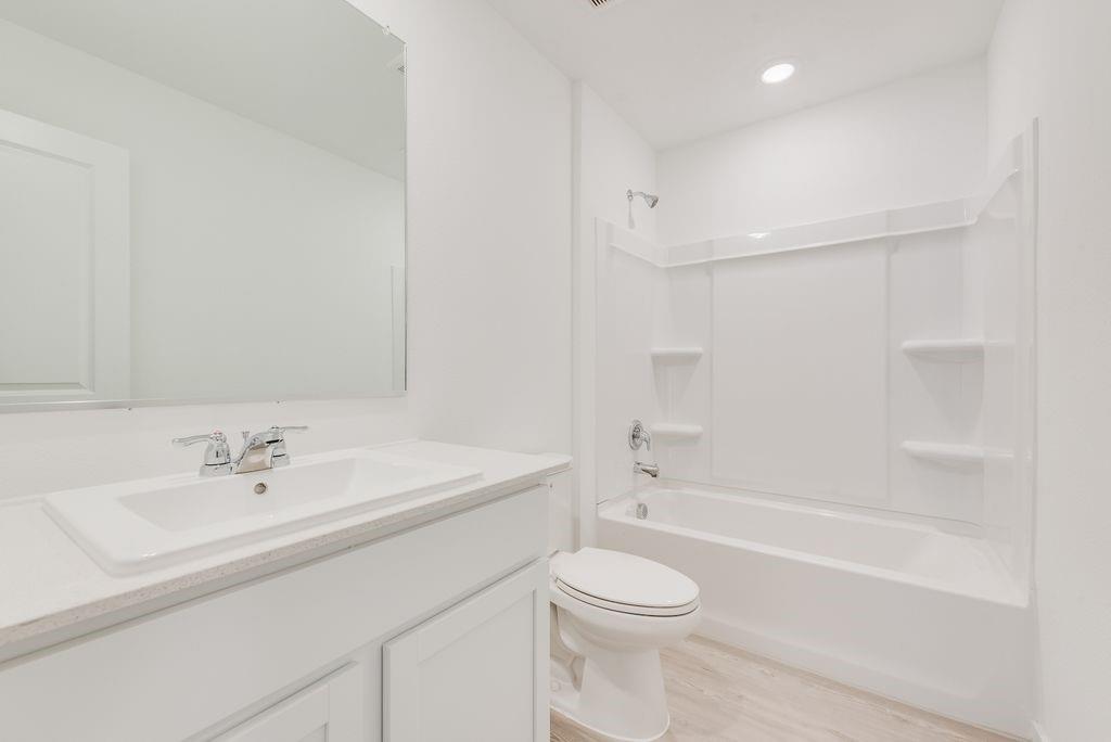 14109 Lampard Street Pilot Point, TX 76258 - Photo 11 of 16 a bathroom with a sink a toilet and shower
