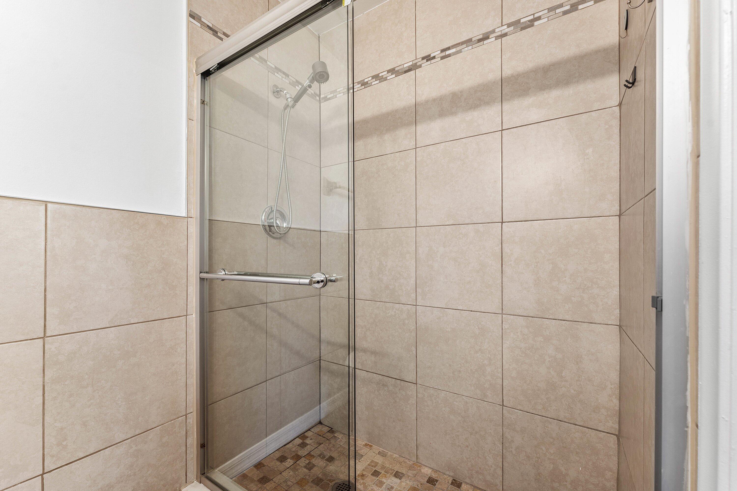 502 Northeast 48th Street Boca Raton, FL 33431 - Photo 21 of 30 a bathroom with a glass shower door