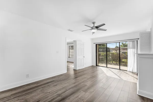 wooden floor in an empty room with a window
