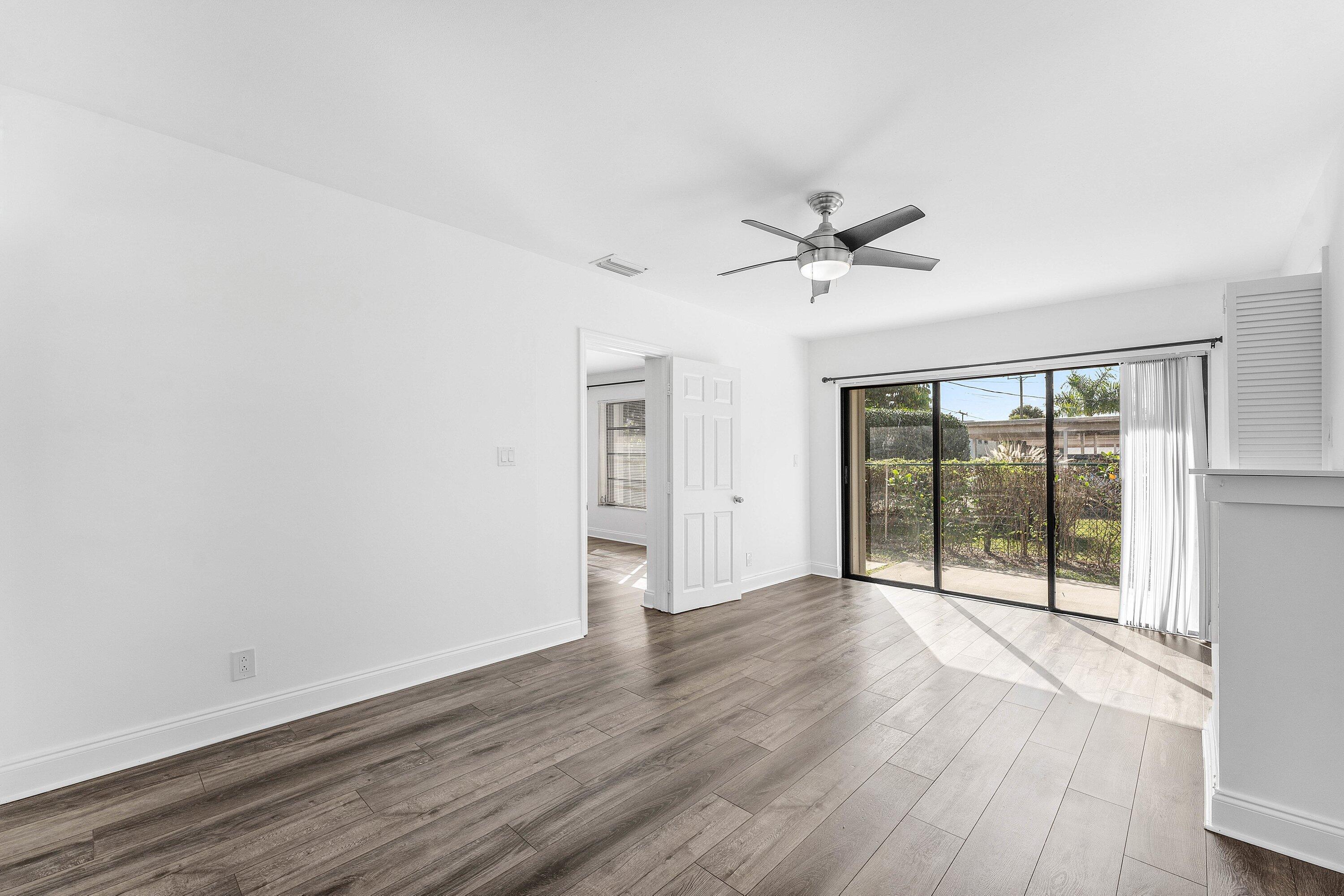 502 Northeast 48th Street Boca Raton, FL 33431 - Photo 26 of 30 wooden floor in an empty room with a window