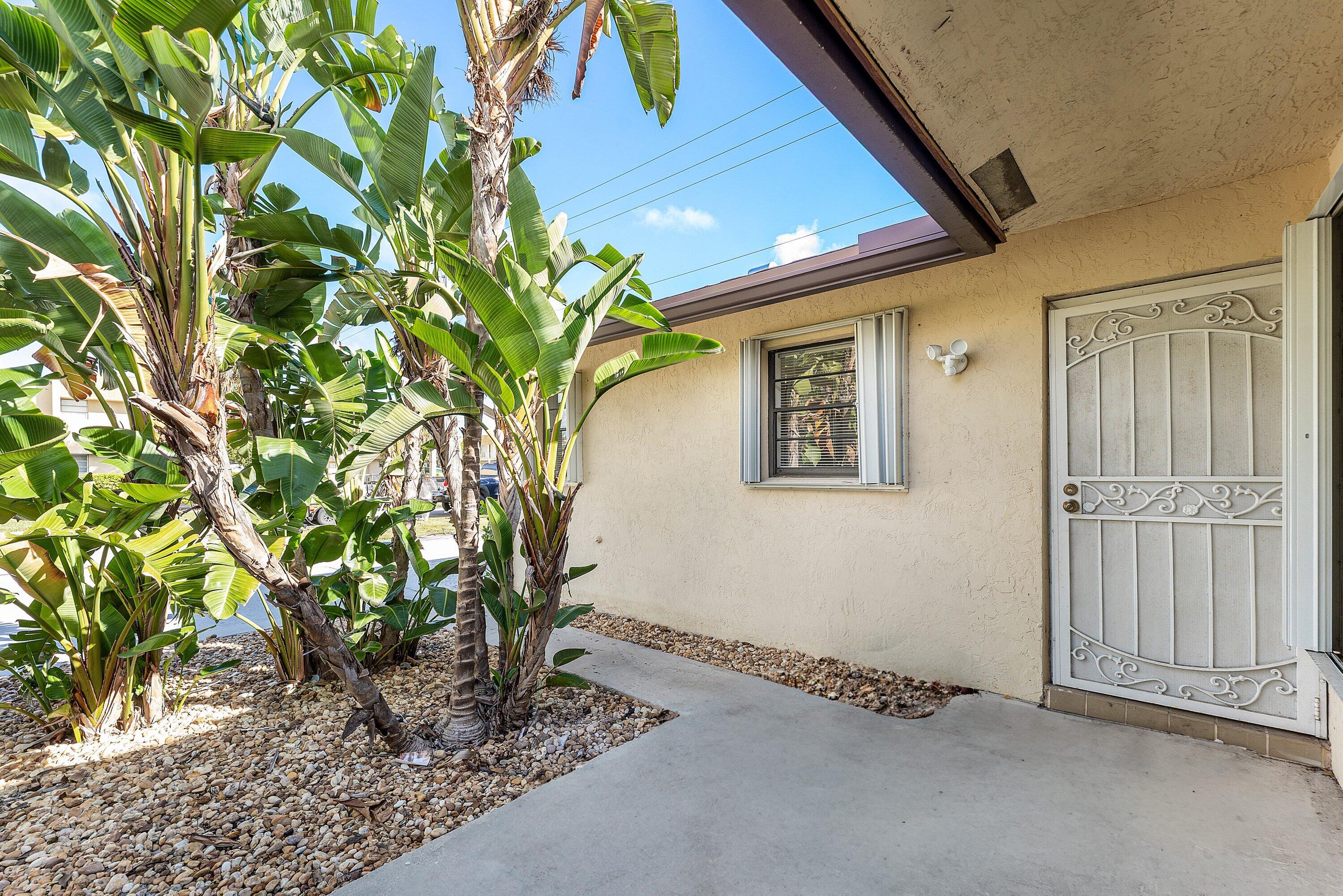 502 Northeast 48th Street Boca Raton, FL 33431 - Photo 3 of 30 a view of a house with a tree