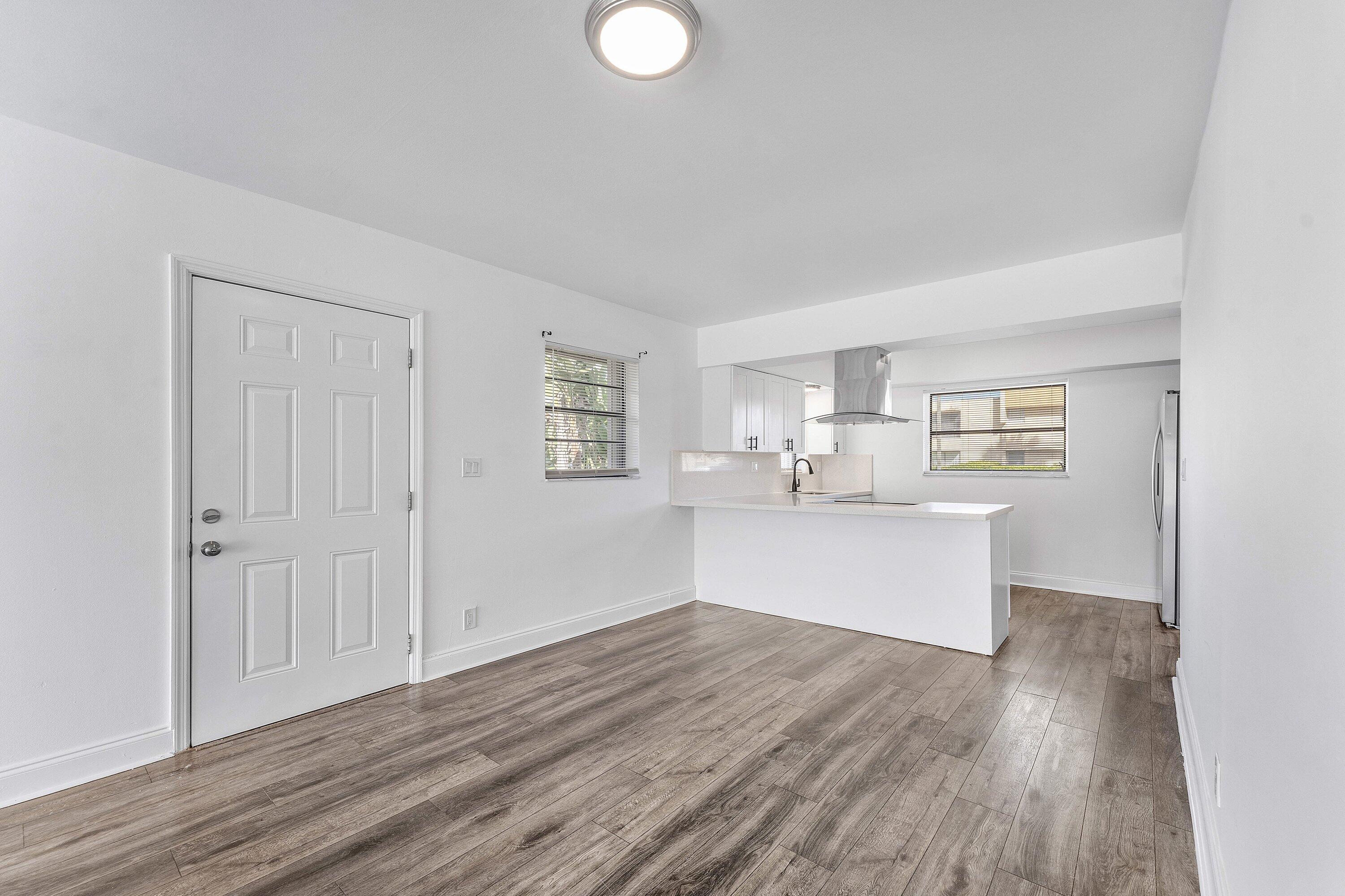 502 Northeast 48th Street Boca Raton, FL 33431 - Photo 4 of 30 a view of kitchen with wooden floor and window