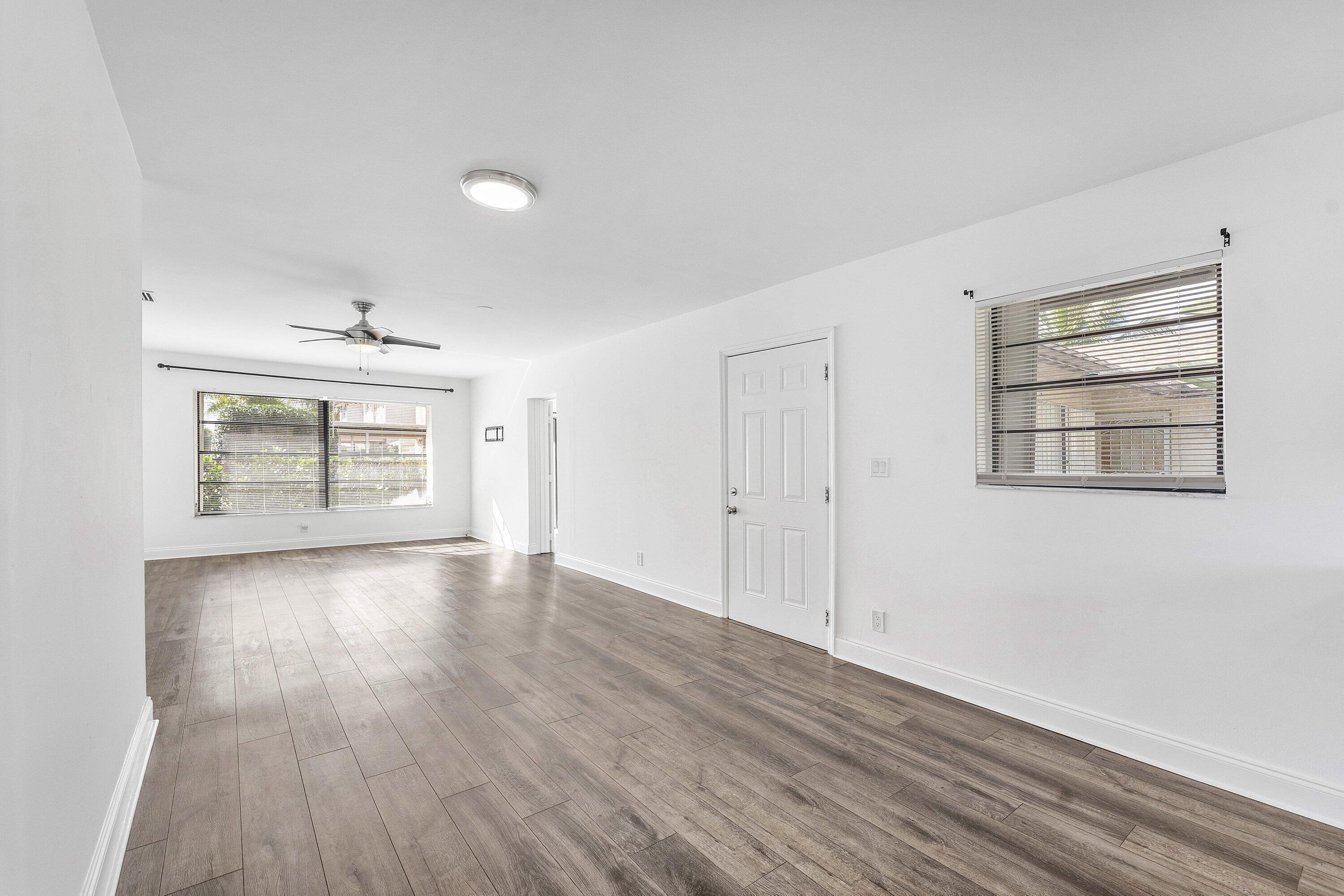 502 Northeast 48th Street Boca Raton, FL 33431 - Photo 5 of 30 wooden floor in an empty room with a window