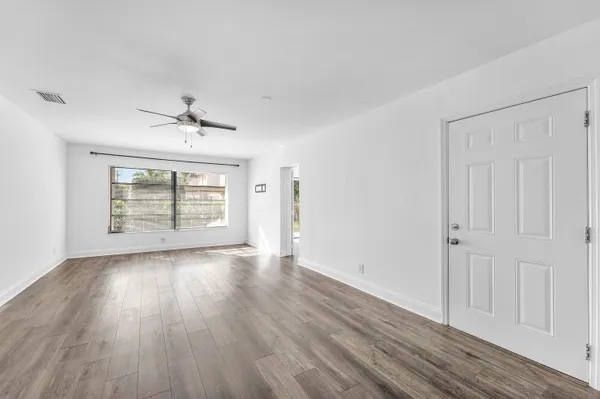 wooden floor in an empty room with a window