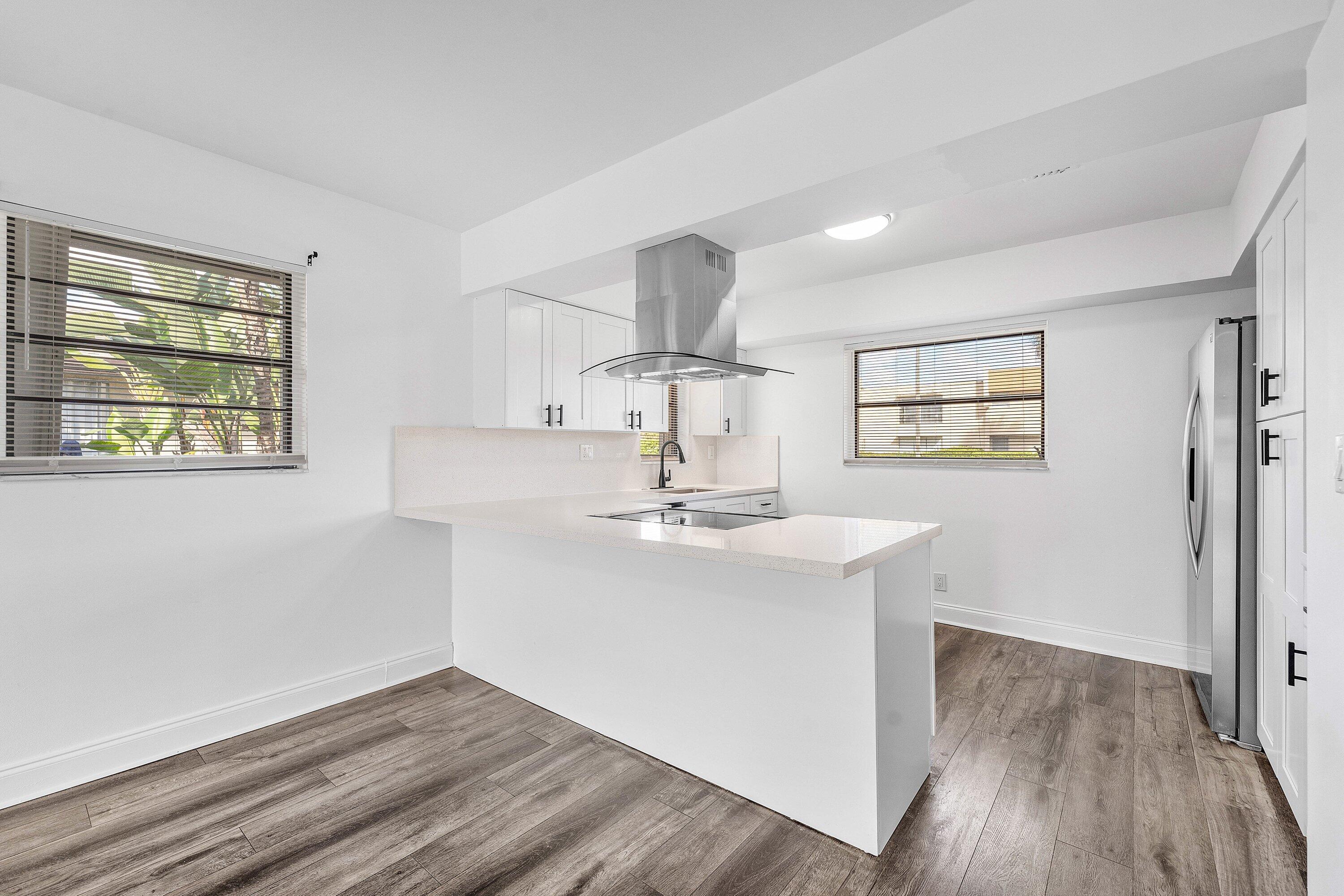 502 Northeast 48th Street Boca Raton, FL 33431 - Photo 8 of 30 a view of kitchen with wooden floor and window