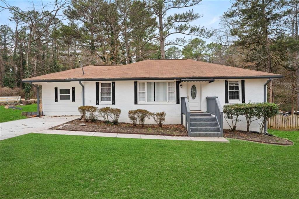 a front view of house with yard and outdoor seating