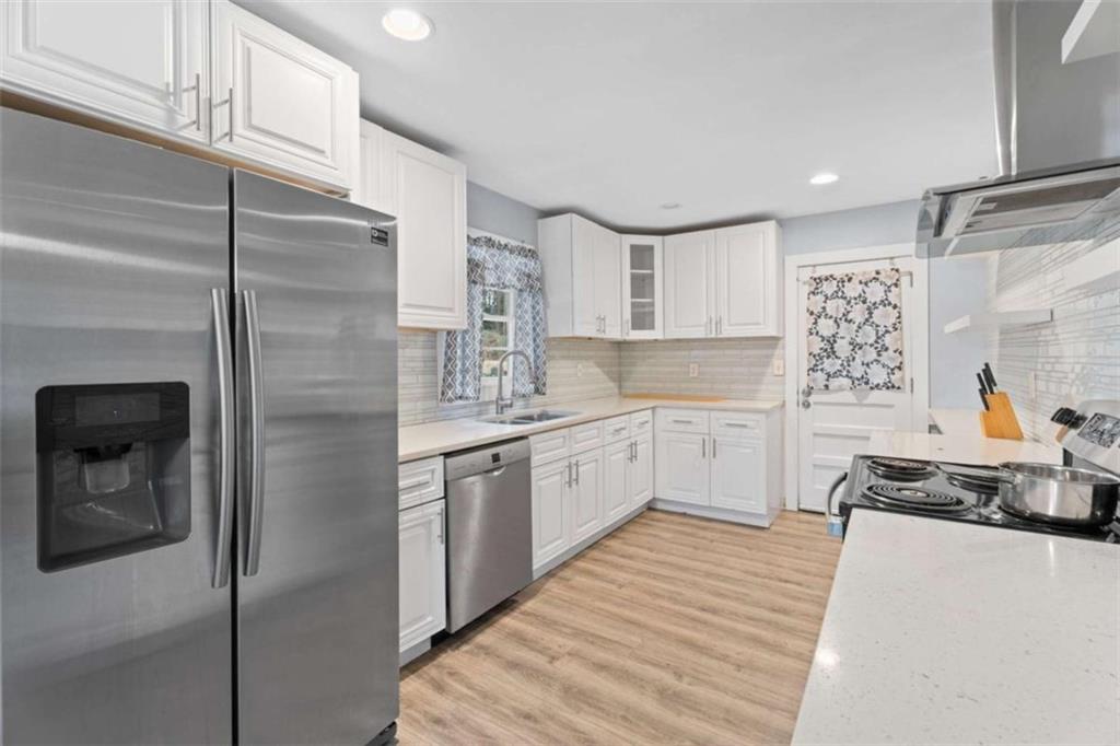 1621 North Columbia Place Decatur, GA 30032 - Photo 26 of 33 a kitchen with white cabinets and white appliances