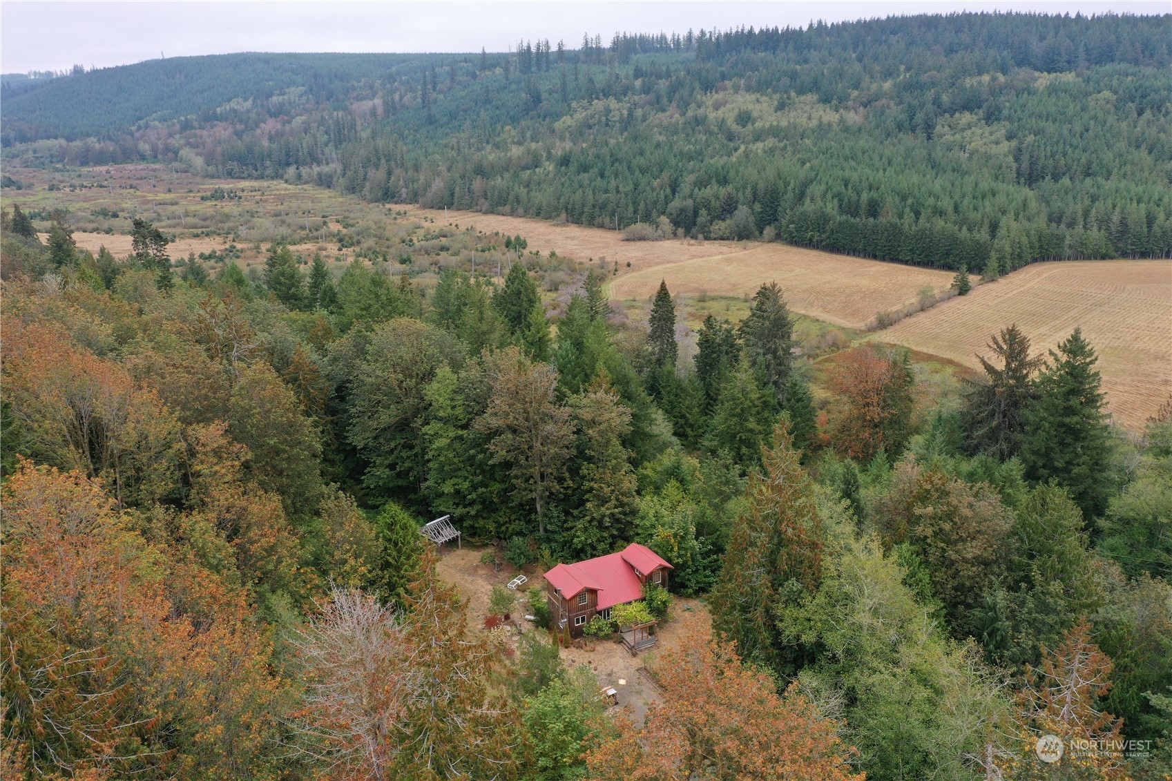 3624 Dabob Road Quilcene, WA 98376 - Photo 3 of 37 a view of a lush green hillside and a building