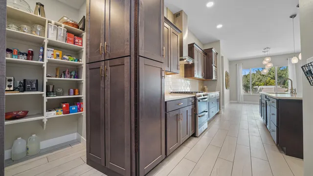 a kitchen with stainless steel appliances granite countertop a refrigerator and a stove top oven