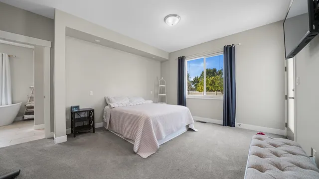 a bedroom with a bed and a window