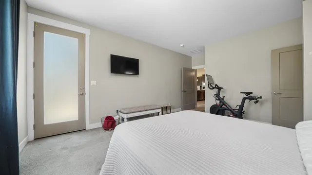 a bedroom with a bed and a flat tv screen