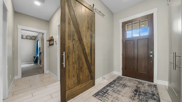 a view of a bathroom with mirror and door