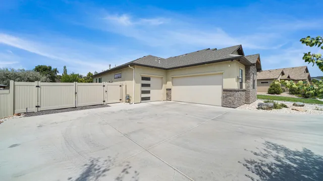 front view of a house with a yard and a garage