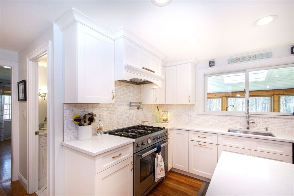 18 Longmeadow Road Scituate, MA 02066 - Photo 9 of 37 a kitchen with stainless steel appliances a sink a stove and a refrigerator