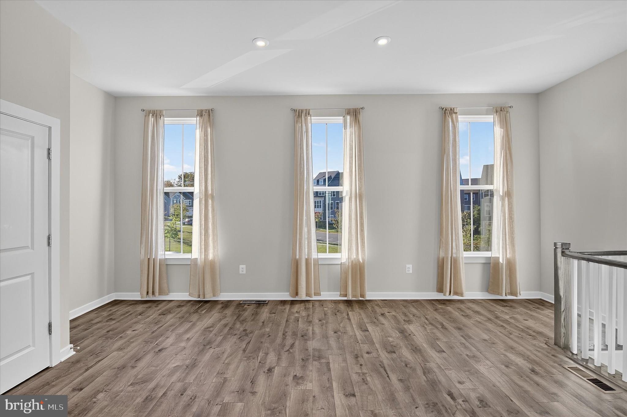 1681 Aspen Poplar Road Dumfries, VA 22026 - Photo 12 of 36 a view of an empty room with wooden floor and window