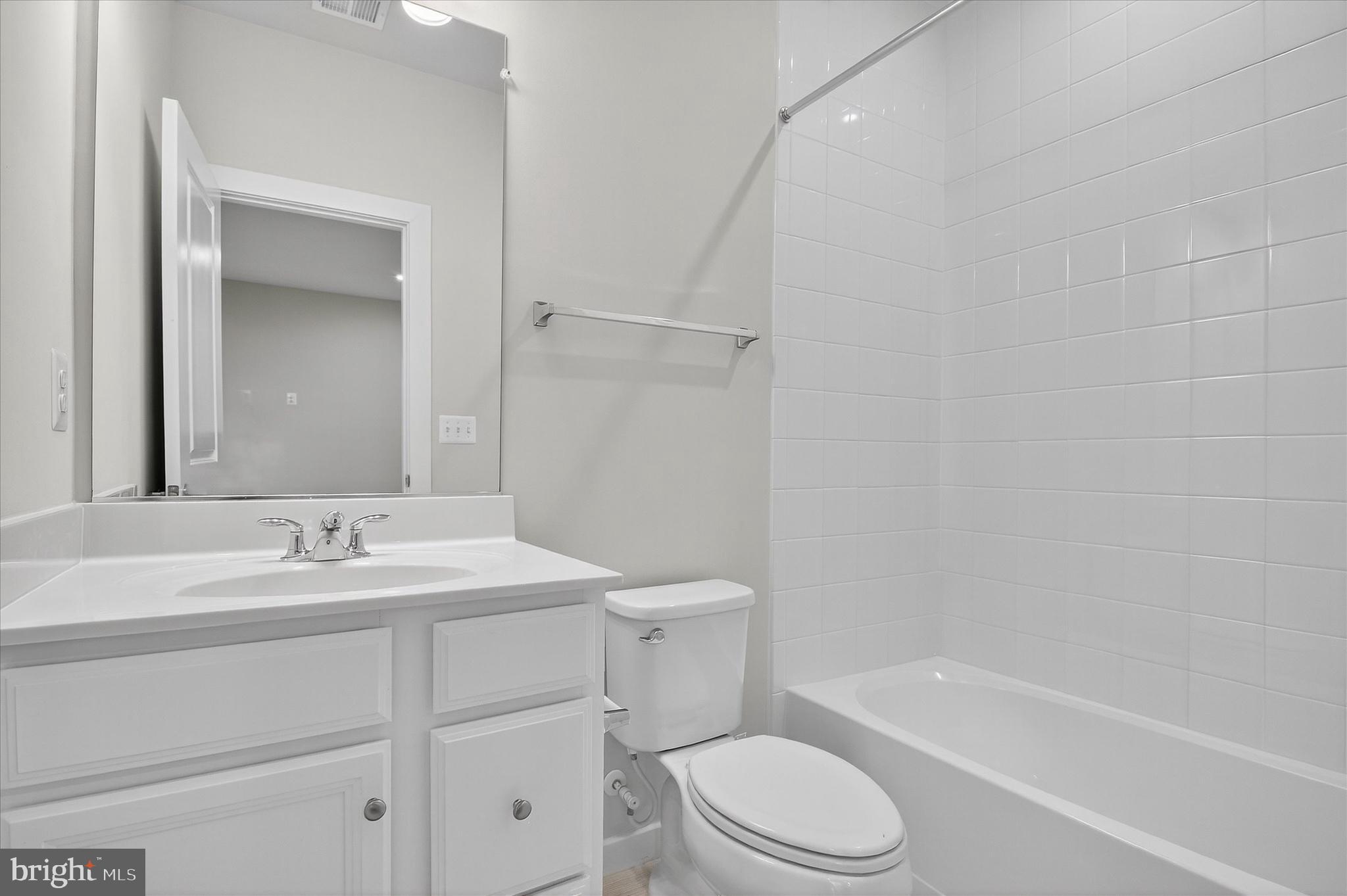 1681 Aspen Poplar Road Dumfries, VA 22026 - Photo 29 of 36 a bathroom with a sink toilet vanity and shower
