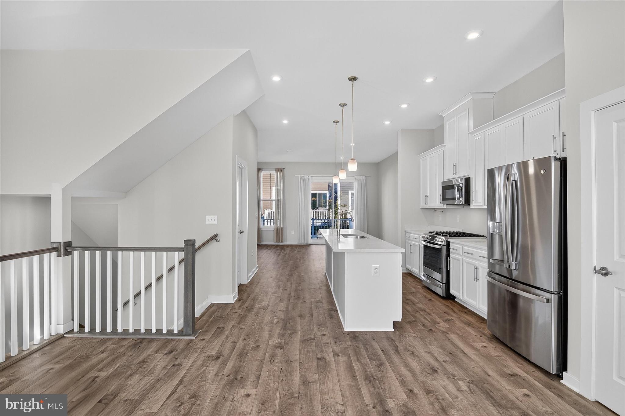 1681 Aspen Poplar Road Dumfries, VA 22026 - Photo 7 of 36 a kitchen with a refrigerator and a stove top oven